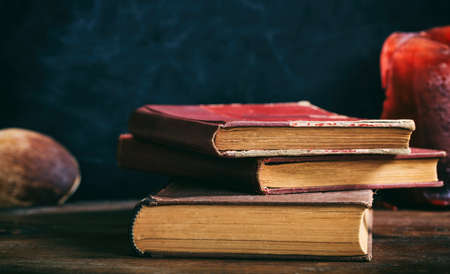 Vintage books stack on dark background - copy spaceの写真素材