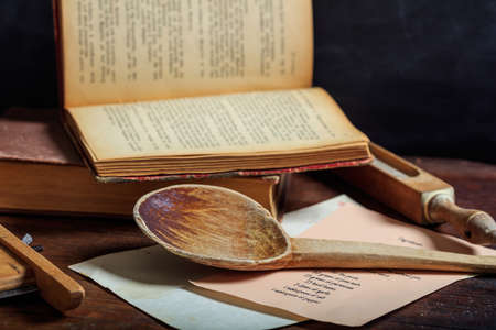 Cookbook concept. Wooden ladle and a cooking recipeの写真素材