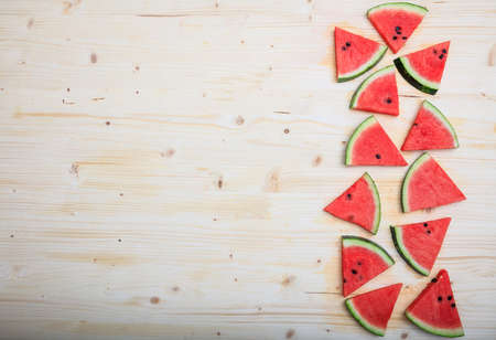 Watermelon pieces on a wooden board- top viewの写真素材