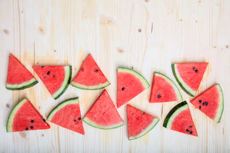 Watermelon pieces on a wooden board- top viewの写真素材