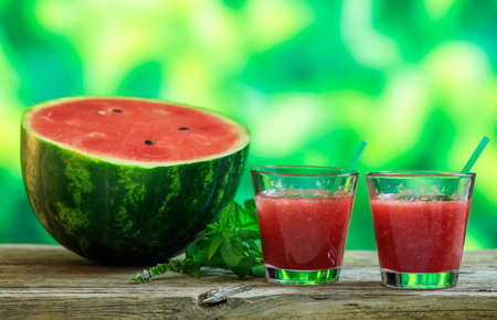 Watermelon smoothies on a wooden table - copy spaceの写真素材