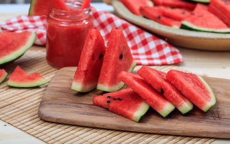 Ripe watermelon slices on a wooden tableの写真素材