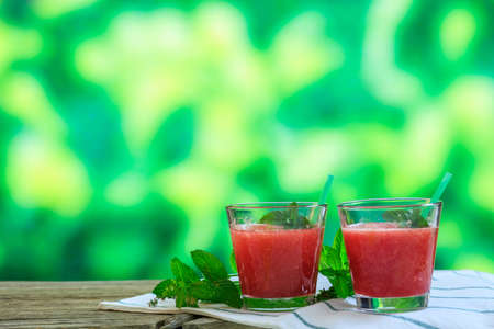 Watermelon smoothies on a wooden table - copy spaceの写真素材
