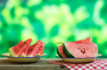 Ripe watermelon slices on a wooden table - copy spaceの写真素材