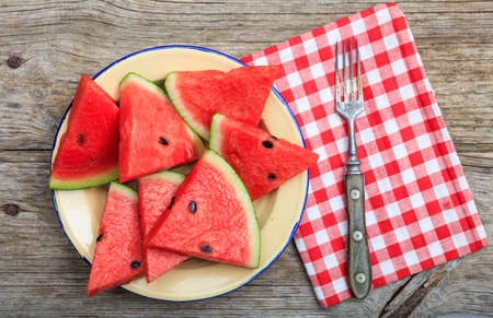 Watermelon slices on a wooden board- top viewの写真素材