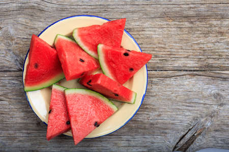 Watermelon slices on a wooden board- top viewの写真素材