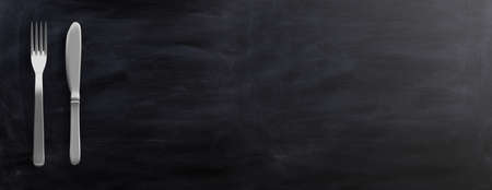 Fork and knife isolated on black background. 3d illustrationの写真素材