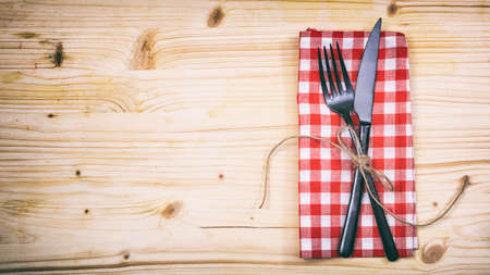 Table setting with fork and knife on wooden backgroundの写真素材