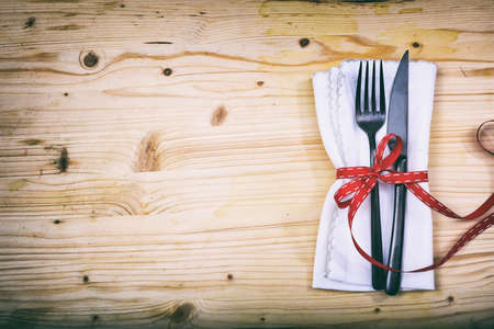 Table setting with fork and knife on wooden backgroundの写真素材