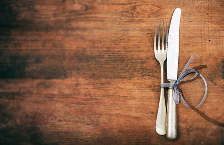 Table setting with fork and knife on wooden backgroundの写真素材