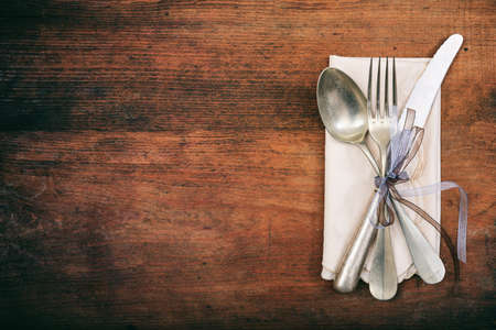 Table setting with fork, spoon and knife on wooden backgroundの写真素材