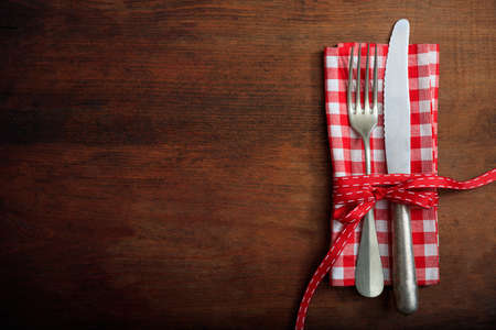 Table setting with fork and knife on wooden backgroundの写真素材