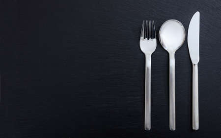 Set of cutlery isolated on black background.の写真素材