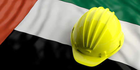 Yellow construction hat over UAE  flag. 3d illustrationの写真素材