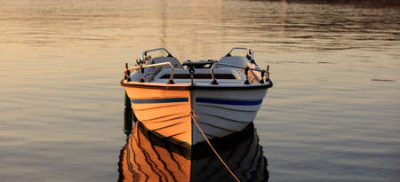Greece, Kea island. Boat in the sea at sunset