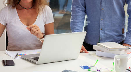 Woman working with a laptop in an office backgroundの写真素材