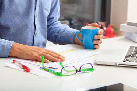 Man studying an analysis report in an office backgroundの写真素材