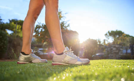 Woman waking in nature, closeup on shoesの写真素材