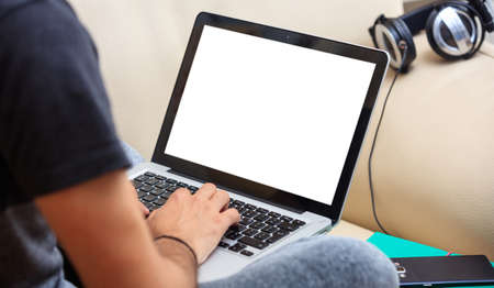 Young man working with a white screen laptop at home, copy space