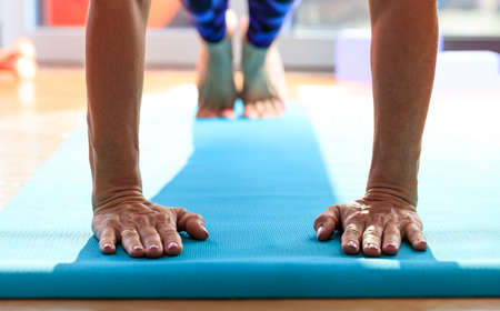 Woman in a pilates class, exercising on wooden floorの写真素材