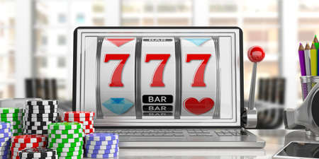 Online gambling concept. Slot machine on a laptop screen and poker chips, office background. 3d illustrationの写真素材