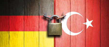 Turkey and Germany relations.Turkey and Germany flags on wooden door with padlock. 3d illustrationの写真素材