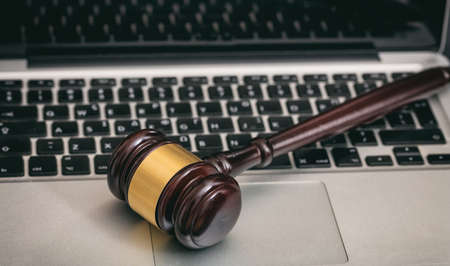 Online auction concept. Auction or judge gavel on a computer keyboardの写真素材