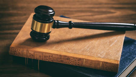 Law gavel on law books, wooden desk, dark backgroundの写真素材