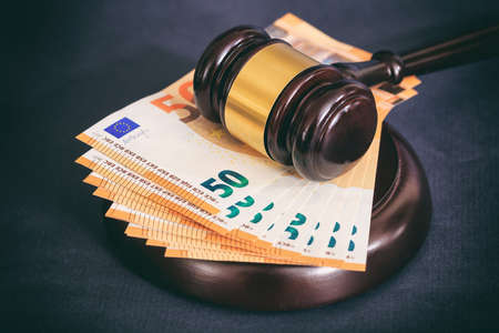 Judge or auction gavel and euro banknotes on black backgroundの写真素材