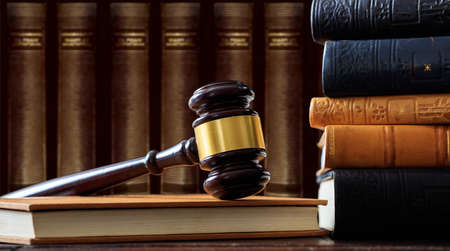 Law gavel on a book, law books background, wooden deskの写真素材