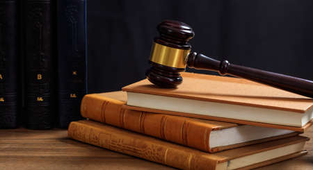 Law gavel on law books, wooden desk, dark backgroundの写真素材