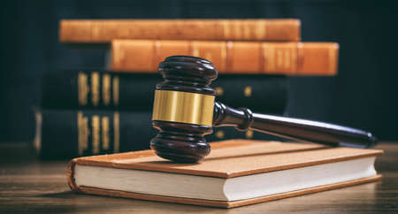 Law gavel on a book, law books background, wooden deskの写真素材