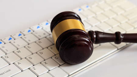 Online auction concept. Auction or judge gavel on a computer keyboardの写真素材