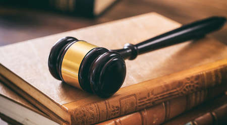 Law gavel on law books, wooden desk, dark backgroundの写真素材