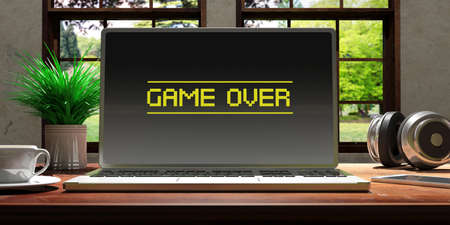 Laptop with game over screen and silver color placed on a wooden desk, Room with a window overlooking the beautiful blurred nature. 3d illustrationの写真素材