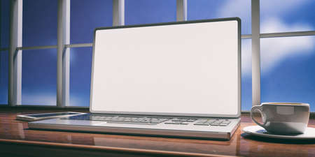 Laptop with white screen placed on a wooden desk. Room with a window overlooking the blurred blue sky. 3d illustrationの写真素材