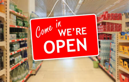 Come in, We are open label on a blur Supermarket backgroundの写真素材