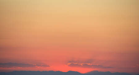 Beautiful sunset on orange sky over mountains background.の写真素材