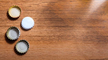 Beer caps on wooden background. Top view, copy spaceの写真素材