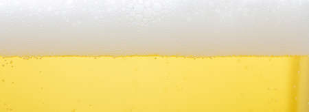A glass of lager beer detail. Closeup on the beer froth and bubblesの写真素材