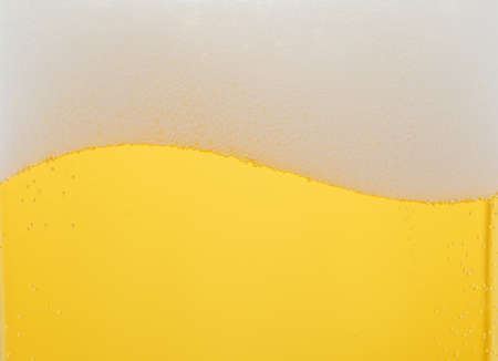 A glass of lager beer detail. Closeup on the beer froth and bubblesの写真素材