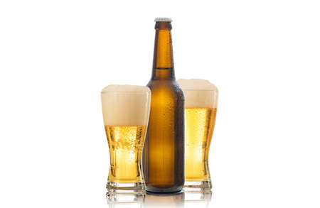 A bottle and two glasses of beer isolated on white backgroundの写真素材