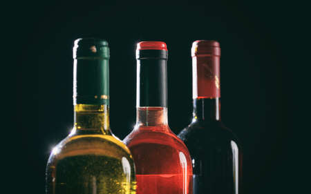 Wine bottles collection on black background, copy spaceの写真素材