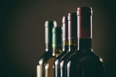Wine bottles collection on black background, copy spaceの写真素材