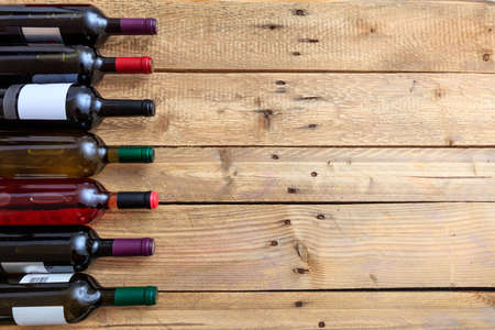 Wine bottles collection on wooden background, copy space, top viewの写真素材