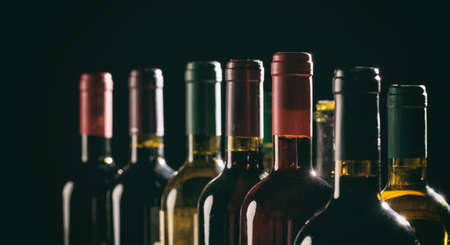 Closed wine bottles collection on black backgroundの写真素材