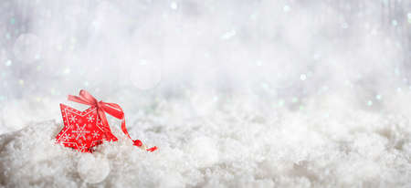Christmas star on abstract cold winter background with snow and defocused lightsの写真素材