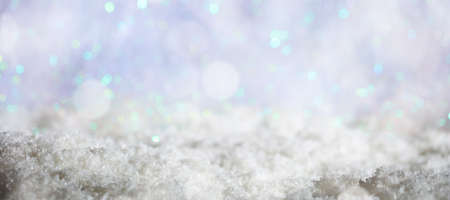 Abstract cold winter background with snow and defocused lightsの写真素材