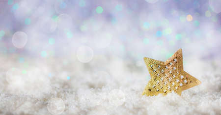 Christmas star on abstract cold winter background with snow and defocused lightsの写真素材