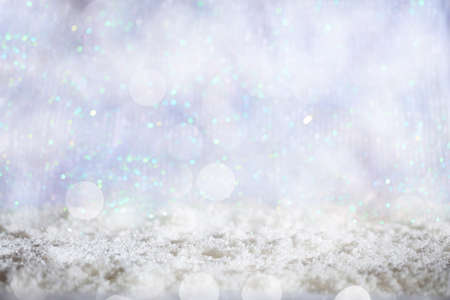 Abstract cold winter background with snow and defocused lightsの写真素材